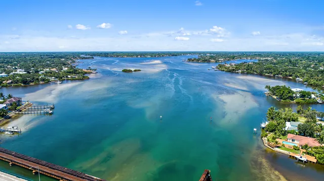 an aerial view of residential house with outdoor space and lake view