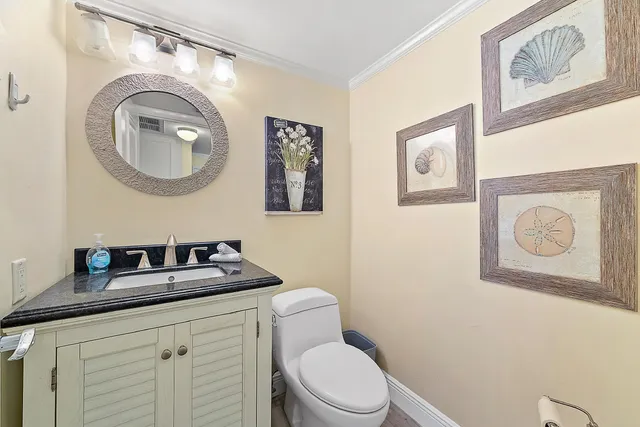 a bathroom with a toilet a sink and a mirror