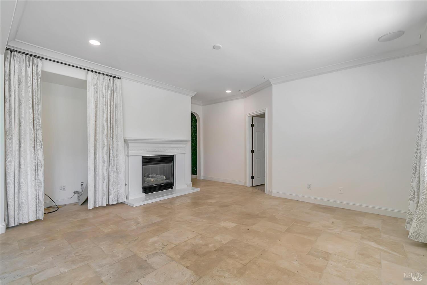 4180 Summer Gate Avenue Vallejo, CA 94591 - Photo 11 of 52 a view of an empty room with a fireplace and a window