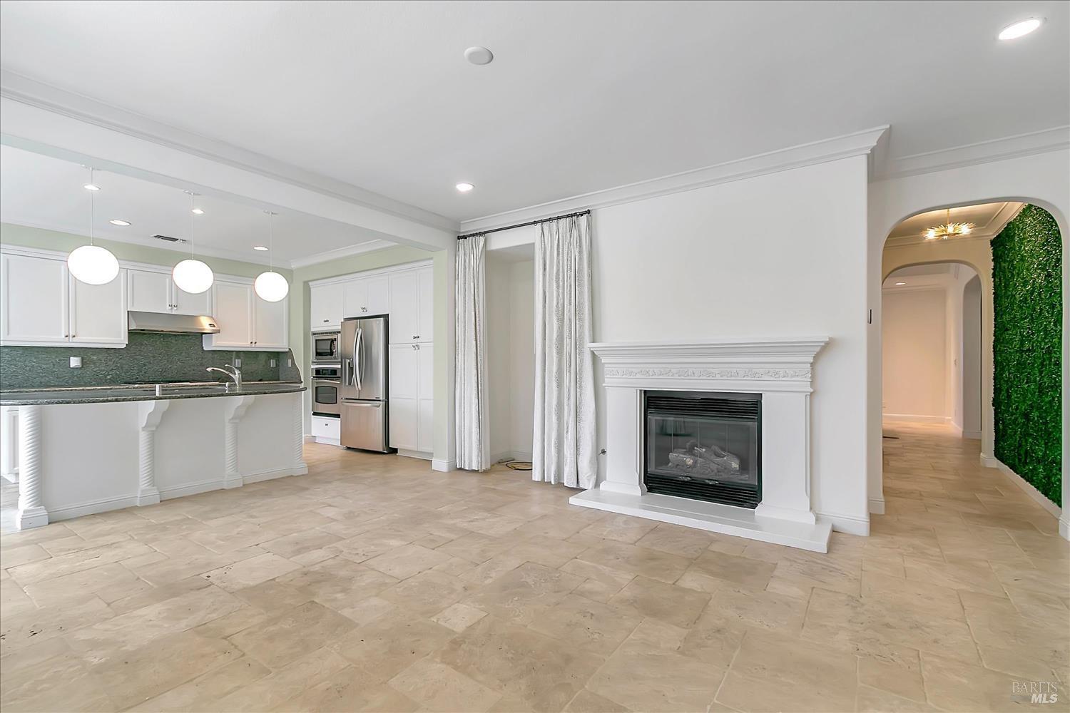 4180 Summer Gate Avenue Vallejo, CA 94591 - Photo 12 of 52 a large kitchen with a fireplace and a sink