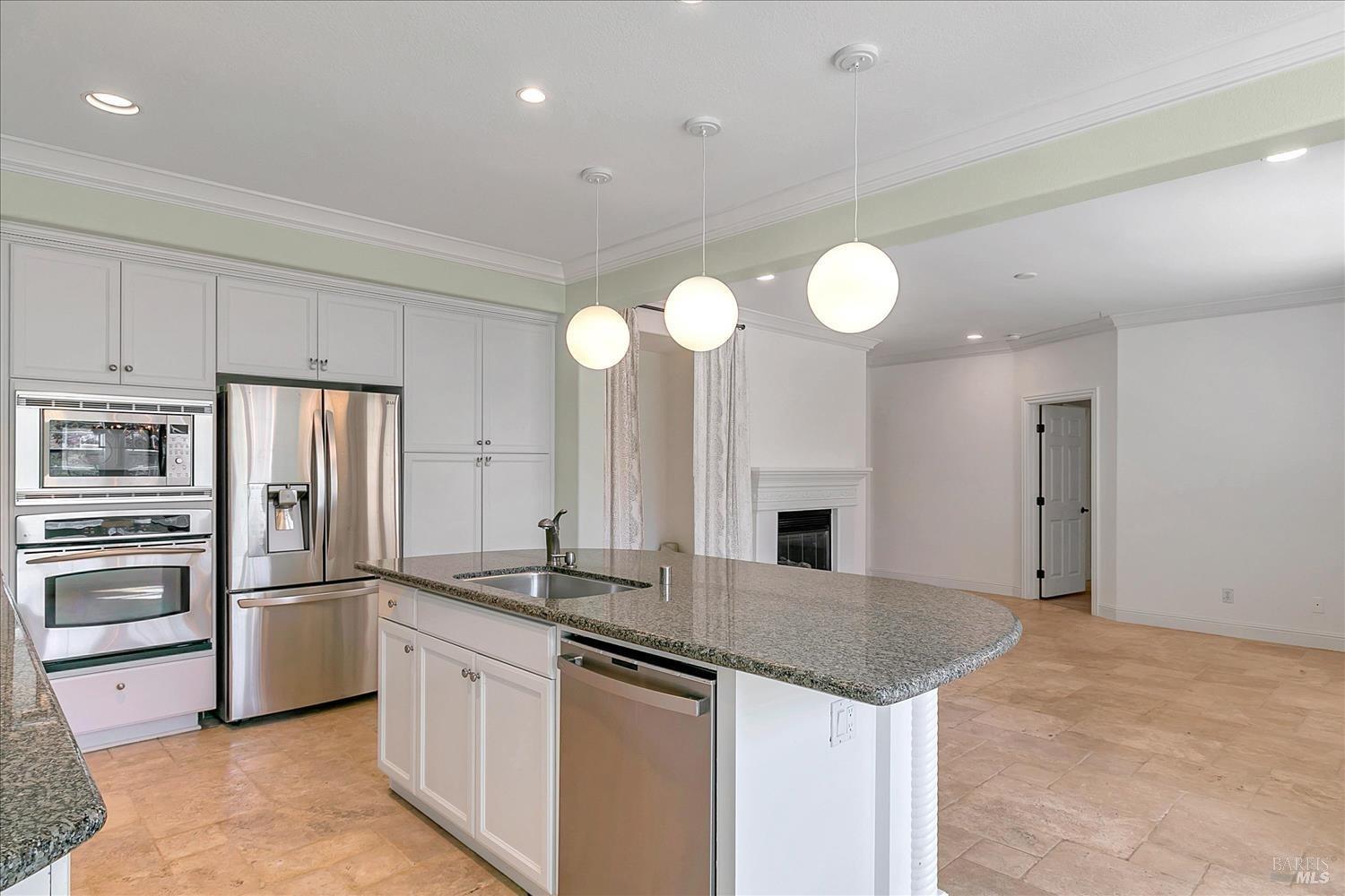 4180 Summer Gate Avenue Vallejo, CA 94591 - Photo 13 of 52 a kitchen with granite countertop a sink stainless steel appliances and cabinets