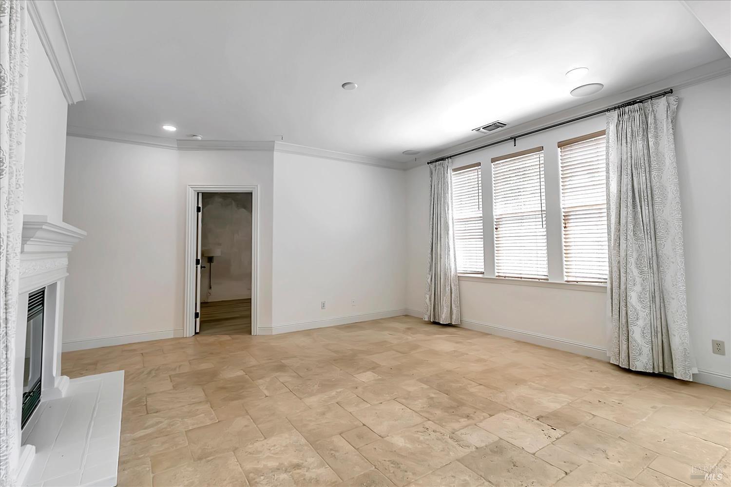 4180 Summer Gate Avenue Vallejo, CA 94591 - Photo 10 of 52 a view of an empty room with a fireplace and a window