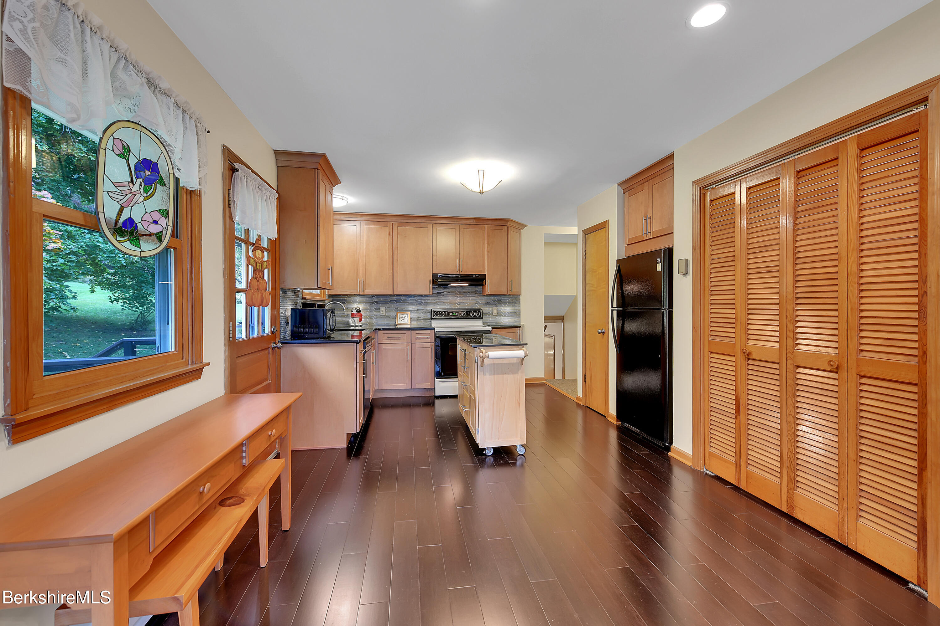 311 Yokun Road Richmond, MA 01201 - Photo 14 of 38 a kitchen with stainless steel appliances wooden floor and a refrigerator
