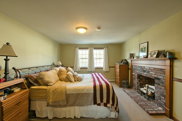 458 Johnson Street North Andover, MA 01845 - Photo 18 of 25 a bed sitting in a bedroom next to a window with tv