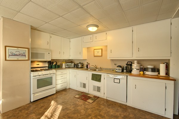 458 Johnson Street North Andover, MA 01845 - Photo 22 of 25 a kitchen with white cabinets and white appliances