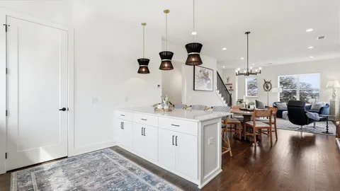 a very nice looking room with a large window and wooden floor