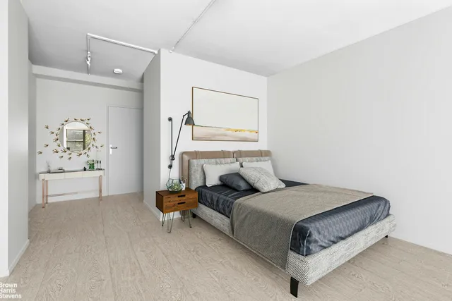 a large bedroom with a large bed and a large window