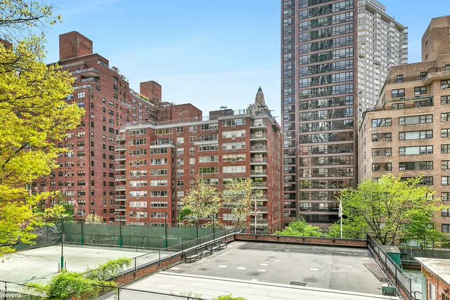 a spacious bedroom with a bed and a large window