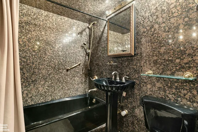 a utility room with stainless steel appliances granite countertop a sink stove and refrigerator