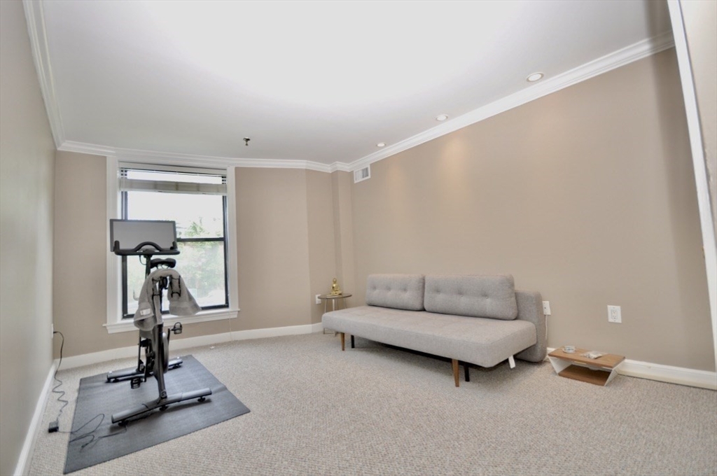 390 Commonwealth Avenue, Unit 210 Boston, MA 02215 - Photo 15 of 19 a living room with a couch and gym equipment