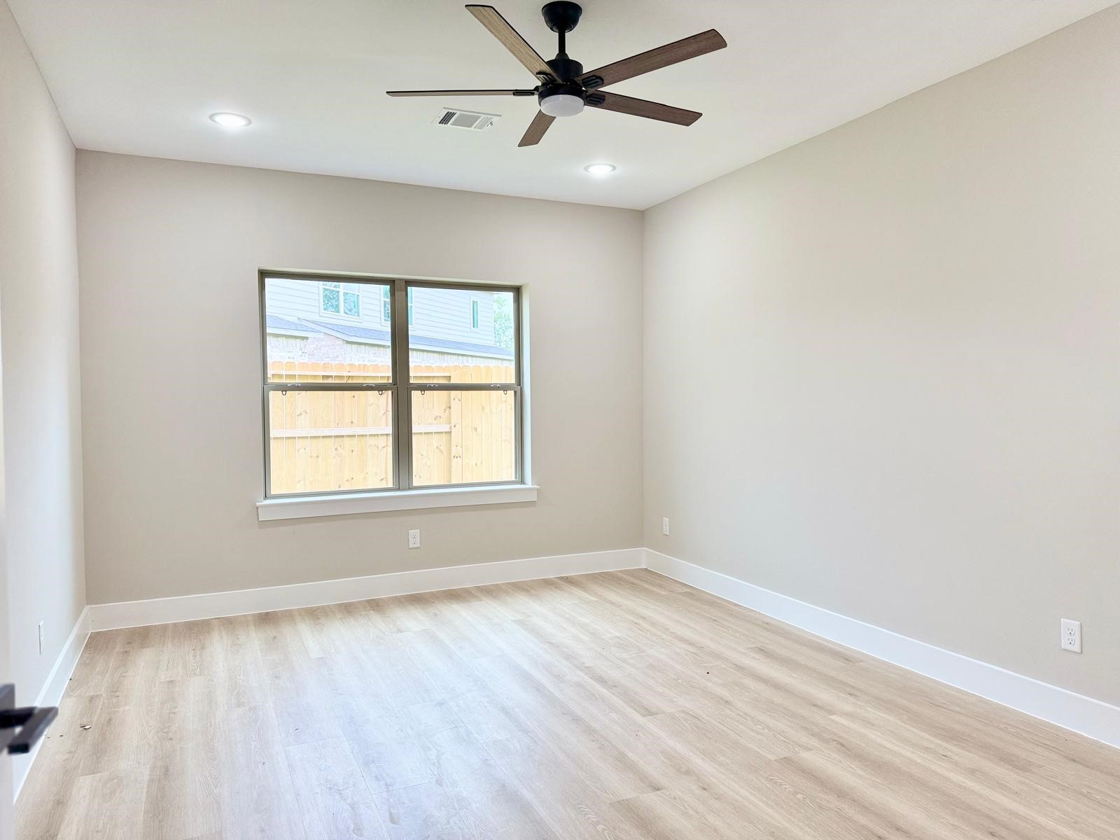 2518 Liguria Ln Spring Spring, TX 77388 - Photo 12 of 36 Spacious and serene primary bedroom featuring ample natural light and modern ceiling fan for ultimate comfort.