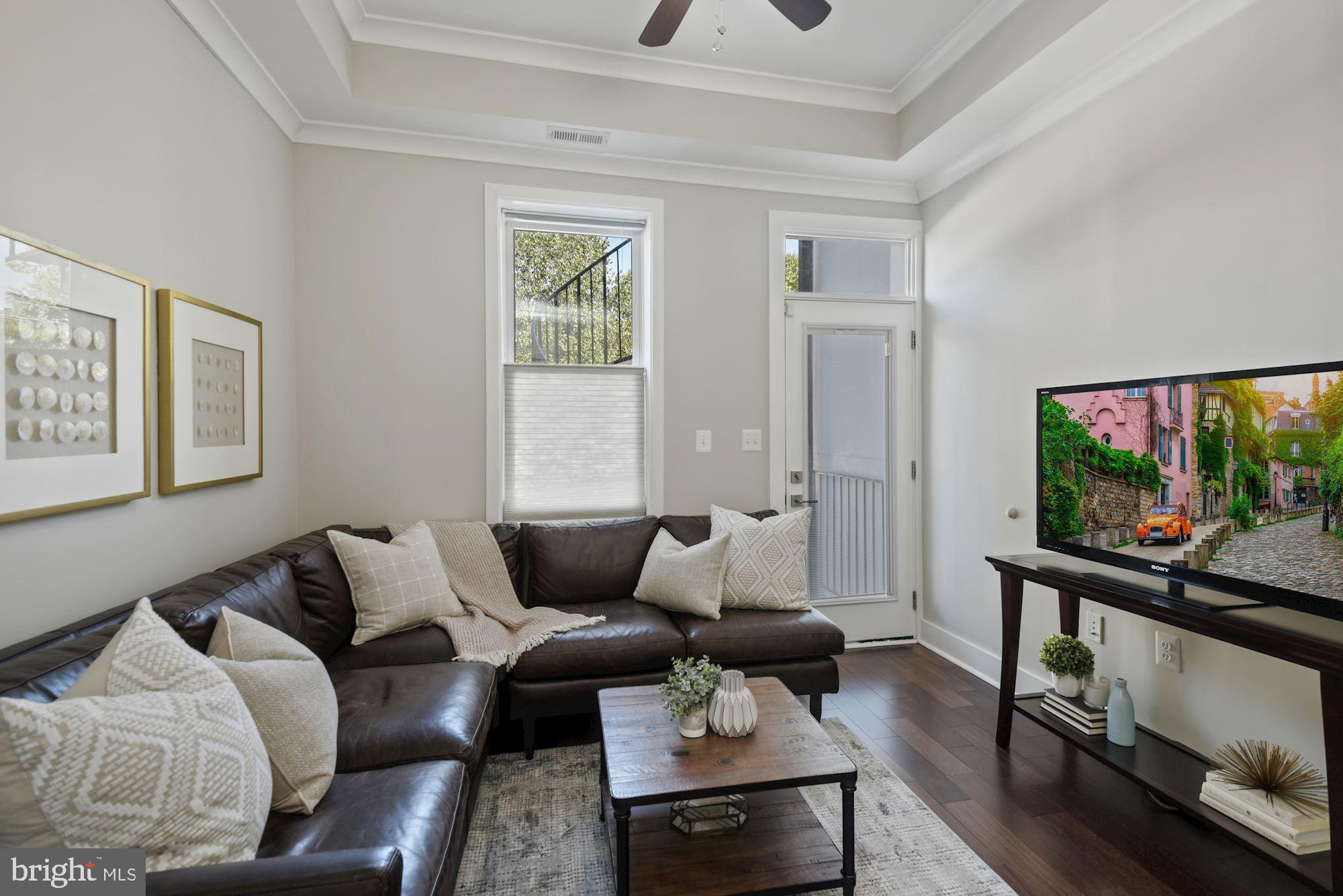73 U Street Northwest, Unit 1 Washington, DC 20001 - Photo 11 of 30 a living room with furniture and a flat screen tv