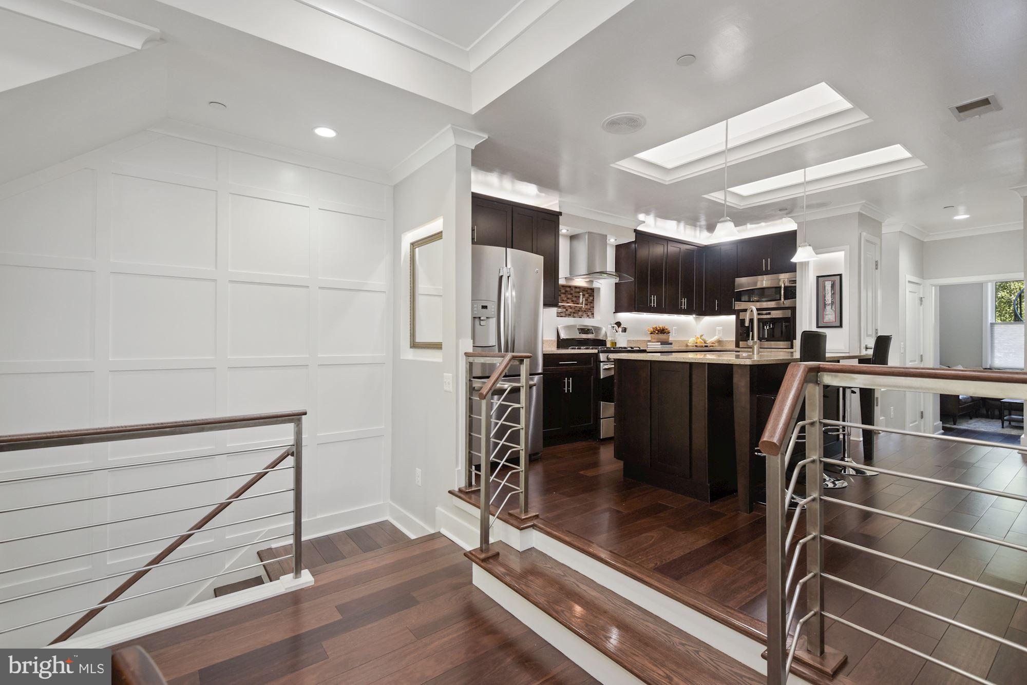 73 U Street Northwest, Unit 1 Washington, DC 20001 - Photo 13 of 30 a kitchen with stainless steel appliances a refrigerator and a stove top oven