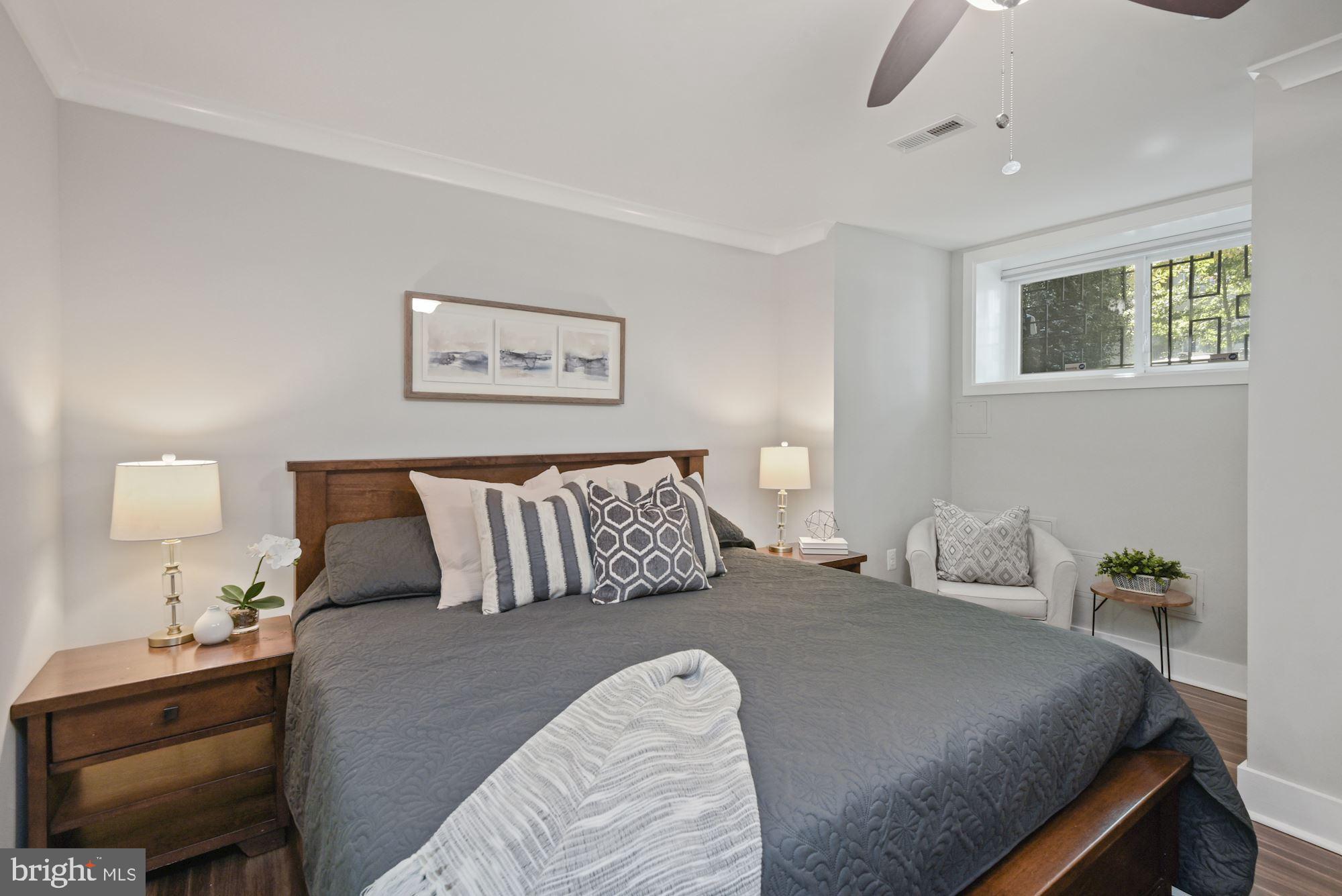 73 U Street Northwest, Unit 1 Washington, DC 20001 - Photo 15 of 30 a bedroom with a bed and a lamp on a dresser