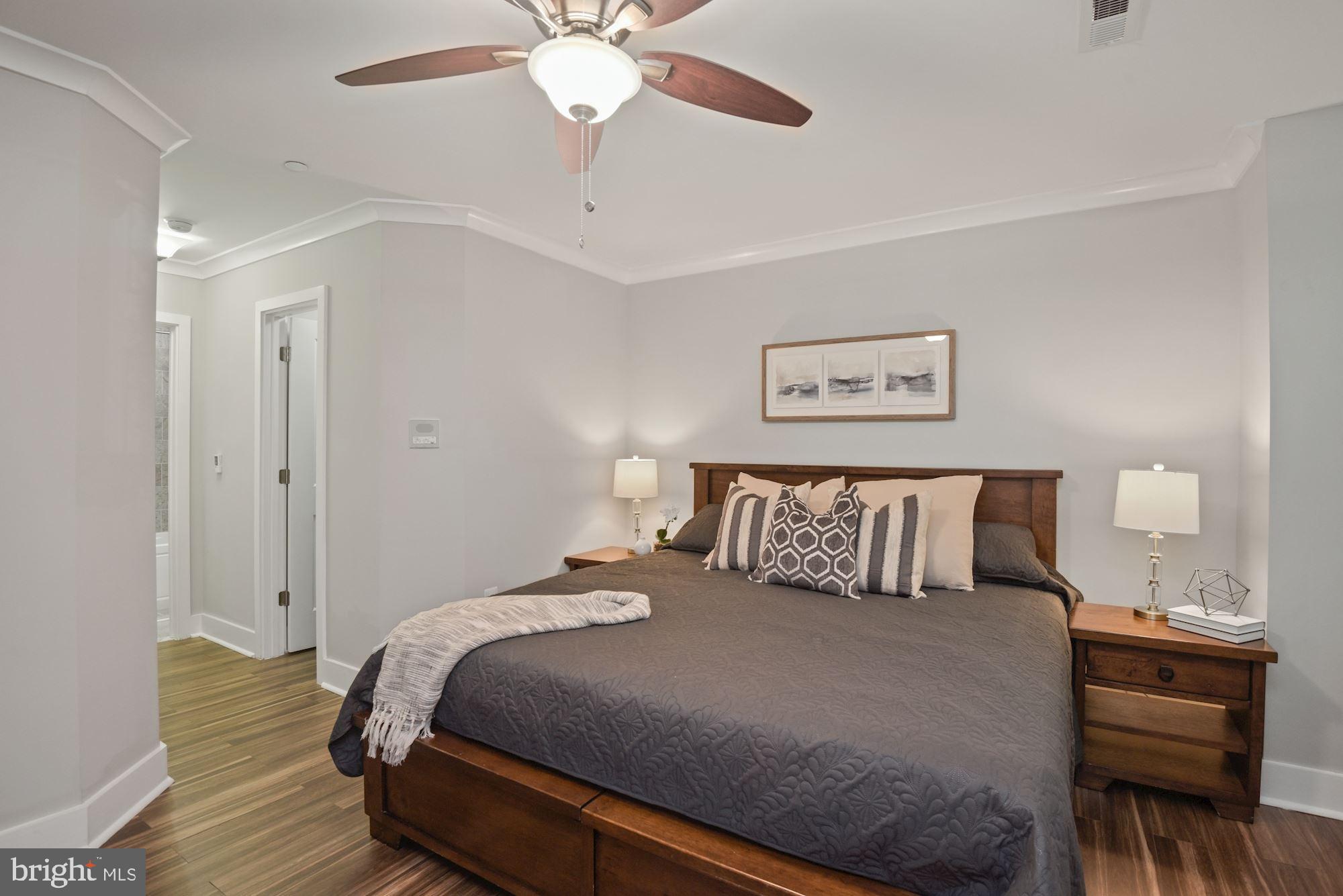 73 U Street Northwest, Unit 1 Washington, DC 20001 - Photo 16 of 30 a bedroom with a large bed and a chandelier
