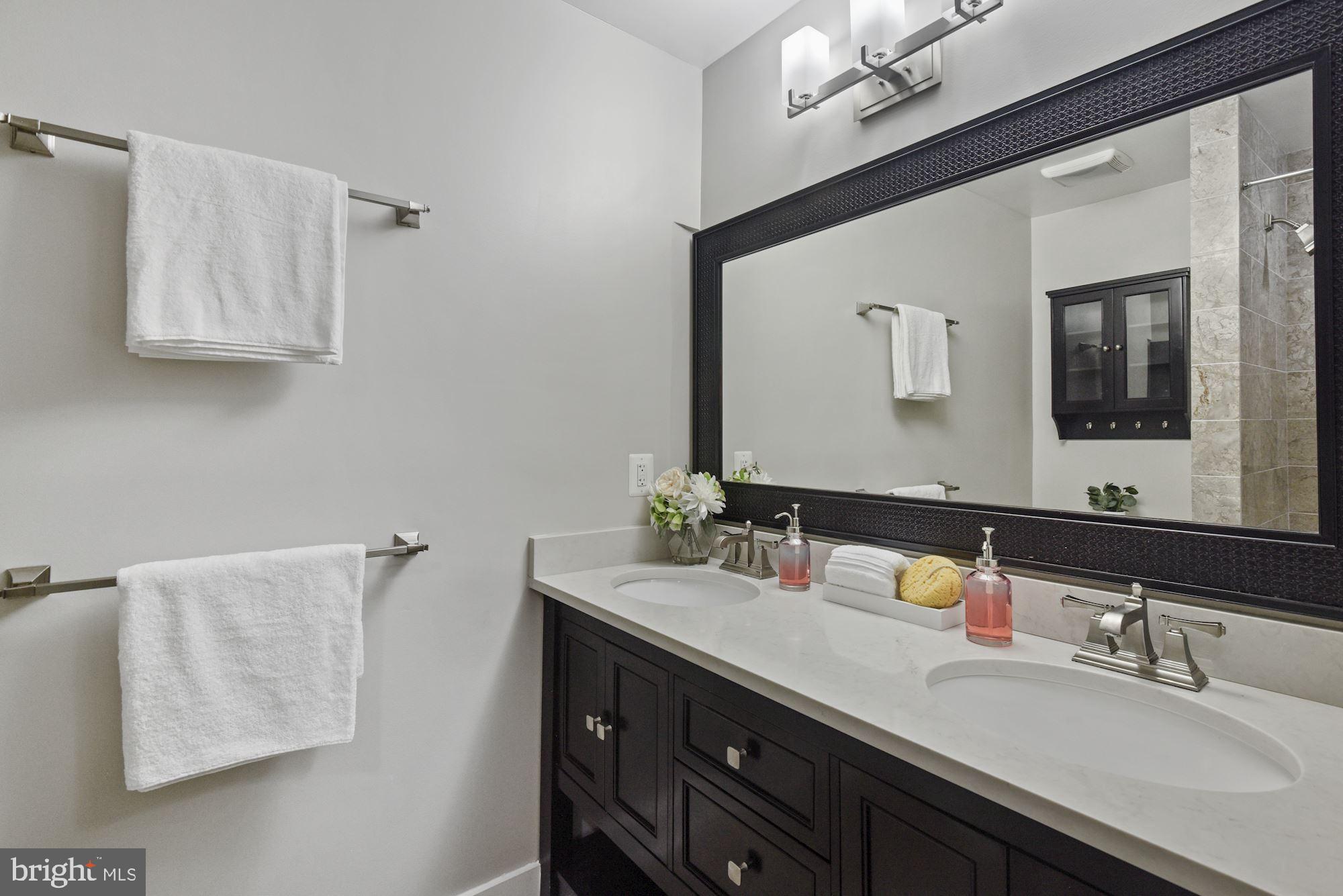 73 U Street Northwest, Unit 1 Washington, DC 20001 - Photo 17 of 30 a bathroom with a double vanity sink a mirror and a