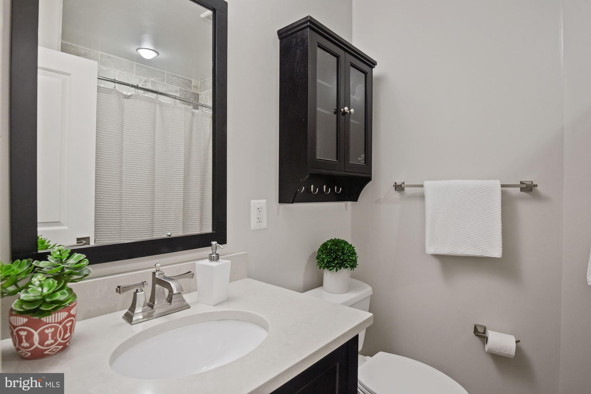73 U Street Northwest, Unit 1 Washington, DC 20001 - Photo 22 of 30 a bathroom with a sink toilet and mirror