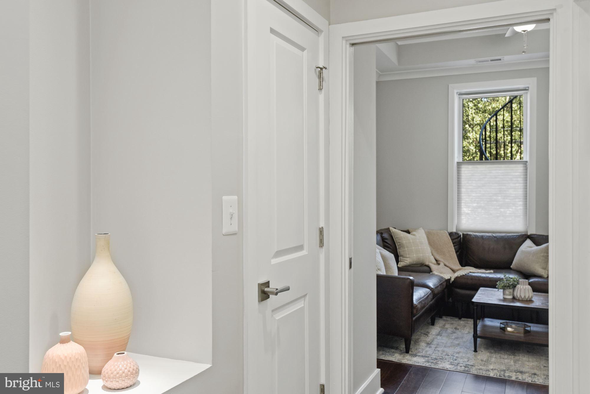 73 U Street Northwest, Unit 1 Washington, DC 20001 - Photo 10 of 30 a living room with furniture and a window