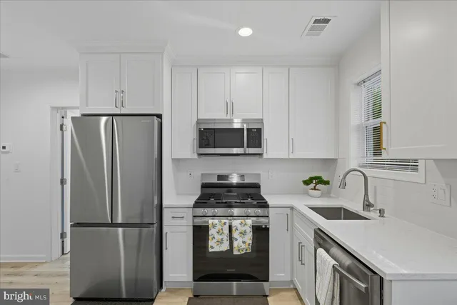 a kitchen with a refrigerator sink and stove