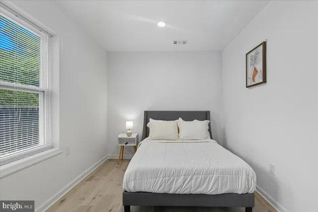 a bedroom with a bed and a window