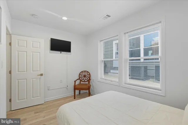 a bedroom with a bed and a television