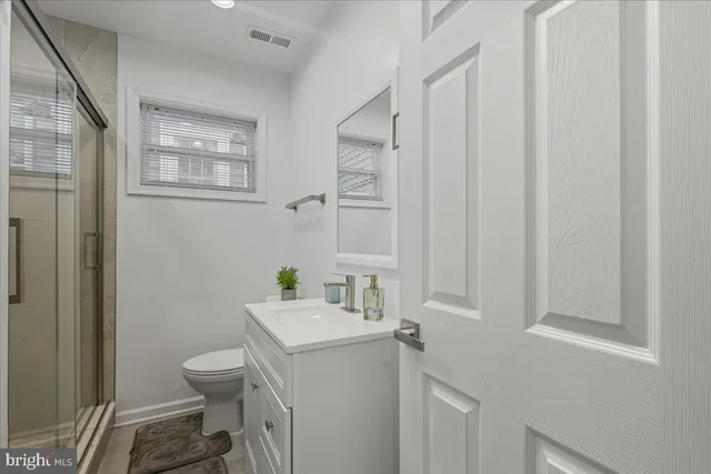 a bathroom with a sink toilet and vanity