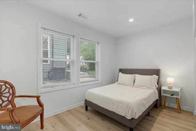 a bedroom with a bed chair and window