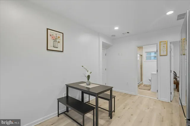 a view of a room with a table and chairs