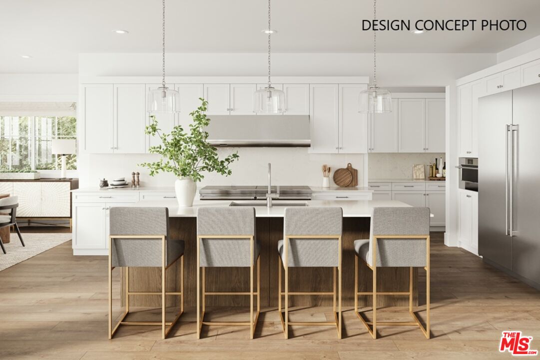 2803 Cardiff Avenue Los Angeles, CA 90034 - Photo 2 of 10 a kitchen with kitchen island granite countertop a dining table chairs and white cabinets