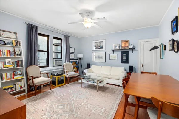 a living room with furniture and a book shelf