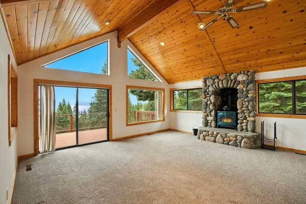 a view of a porch with furniture and floor to ceiling window