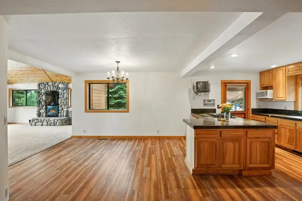 a kitchen with a sink and wooden floor