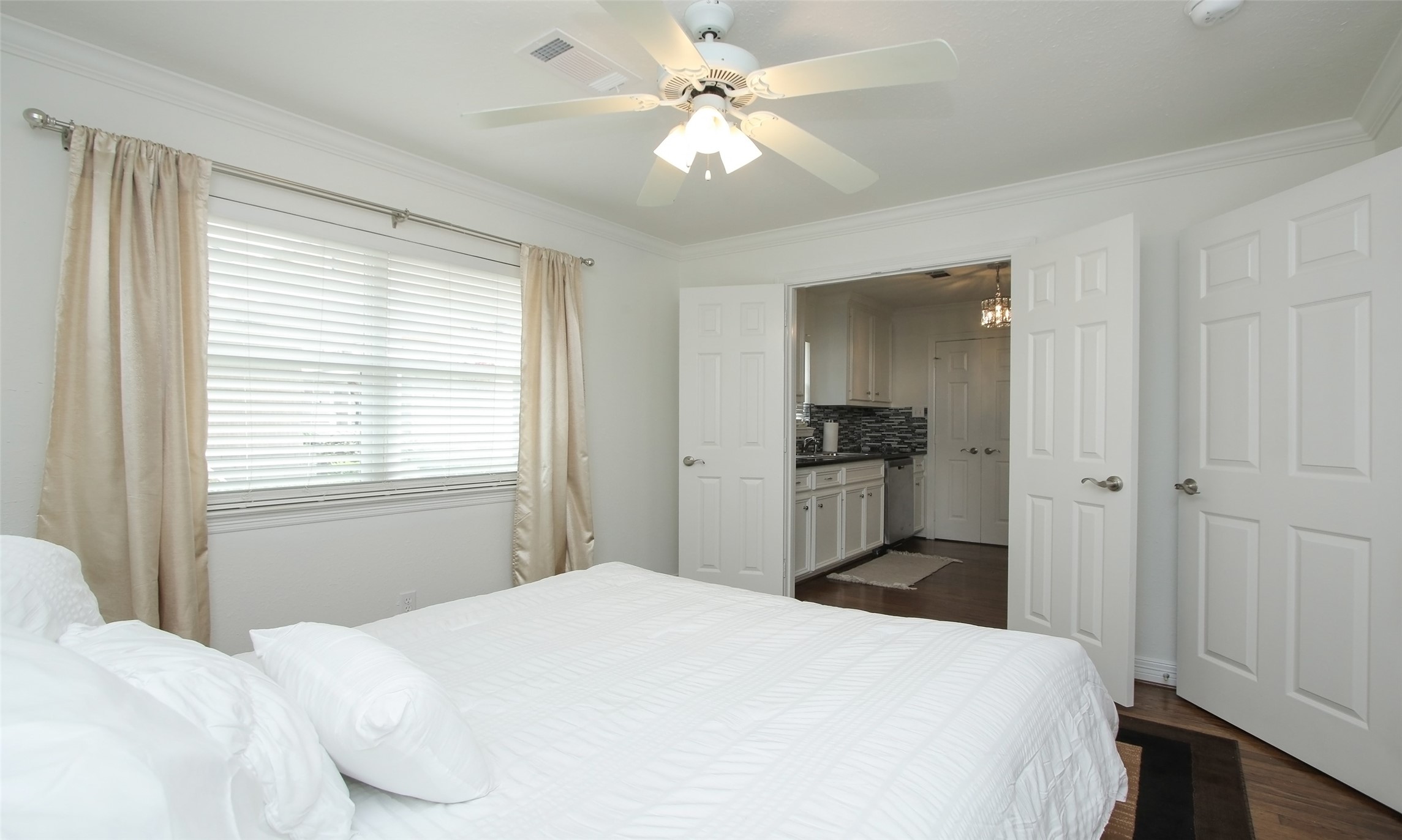 4331 Marina Street, Unit B Houston, TX 77007 - Photo 16 of 37 a bedroom with a bed and a chandelier
