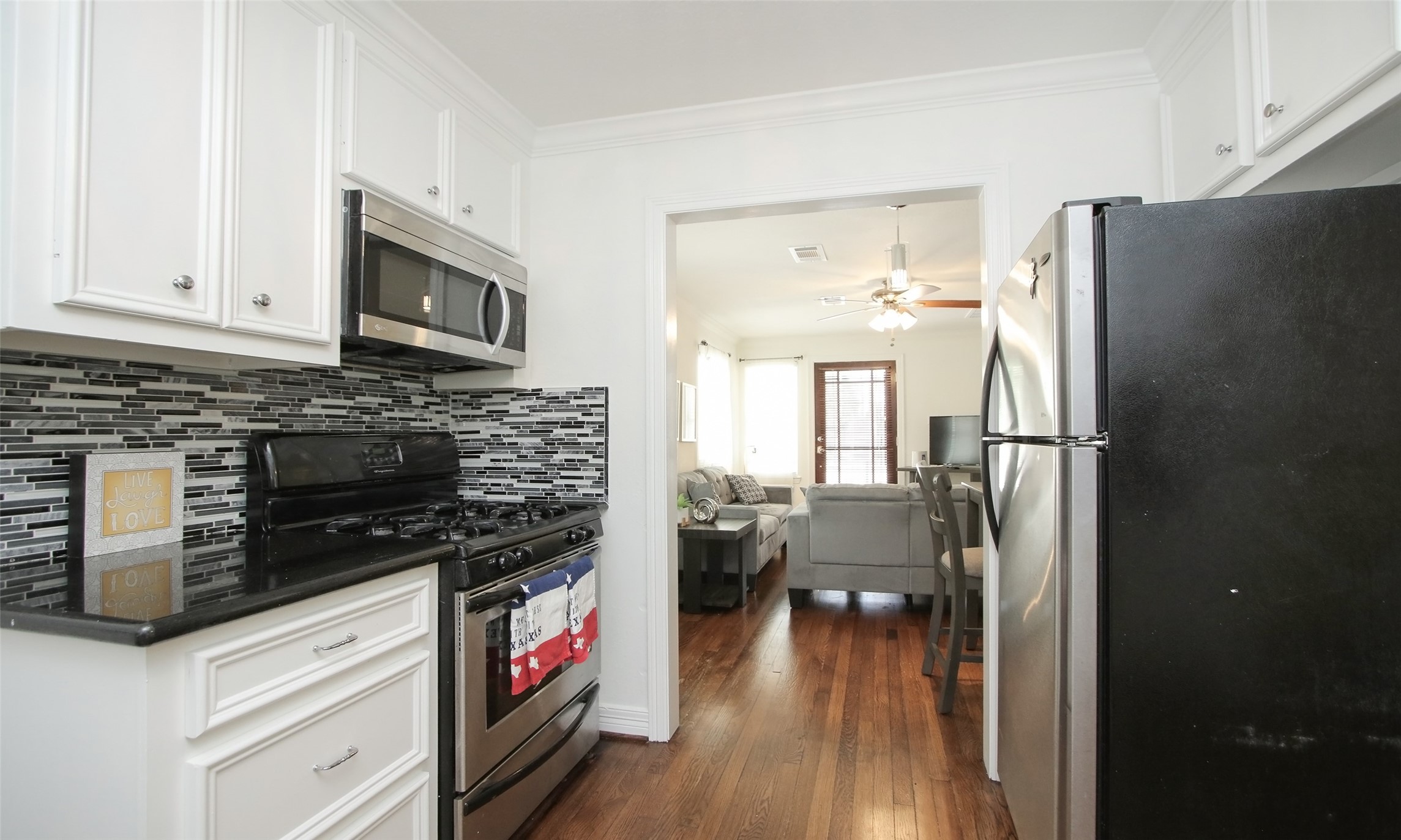 4331 Marina Street, Unit B Houston, TX 77007 - Photo 6 of 37 a kitchen with stainless steel appliances a stove microwave and a refrigerator