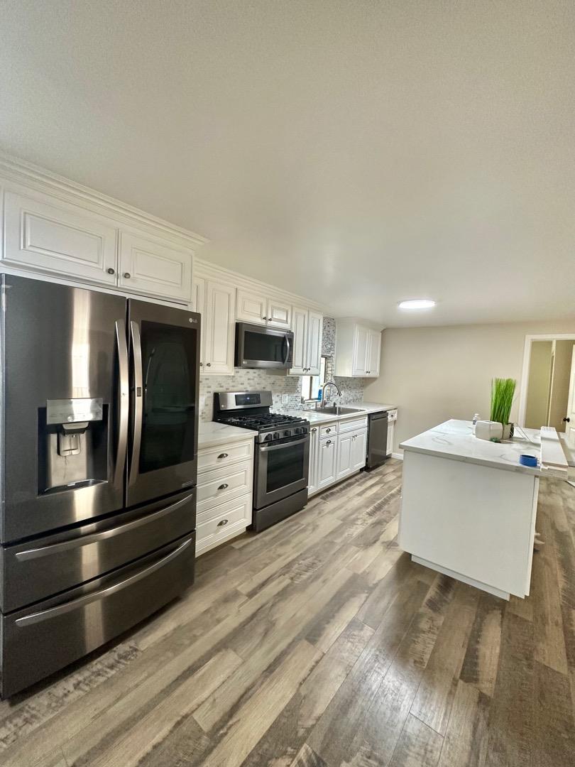 2151 Oakland Road, Unit 246 San Jose, CA 95131 - Photo 1 of 12 a kitchen with stainless steel appliances kitchen island granite countertop a stove top oven and sink