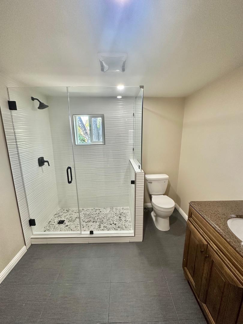 2151 Oakland Road, Unit 246 San Jose, CA 95131 - Photo 6 of 12 a bathroom with a granite countertop sink a toilet and a shower