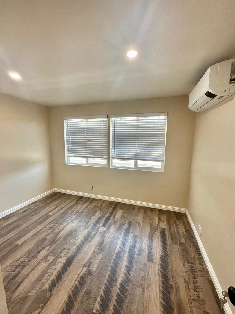 2151 Oakland Road, Unit 246 San Jose, CA 95131 - Photo 7 of 12 an empty room with wooden floor and windows