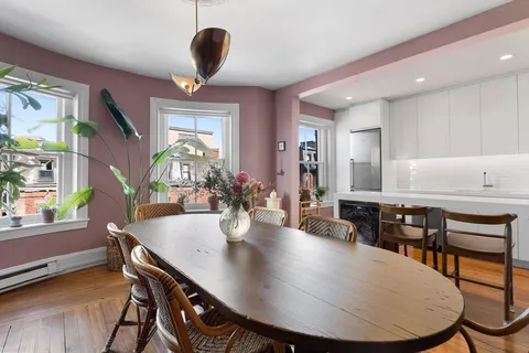 a view of a dining room with furniture and window