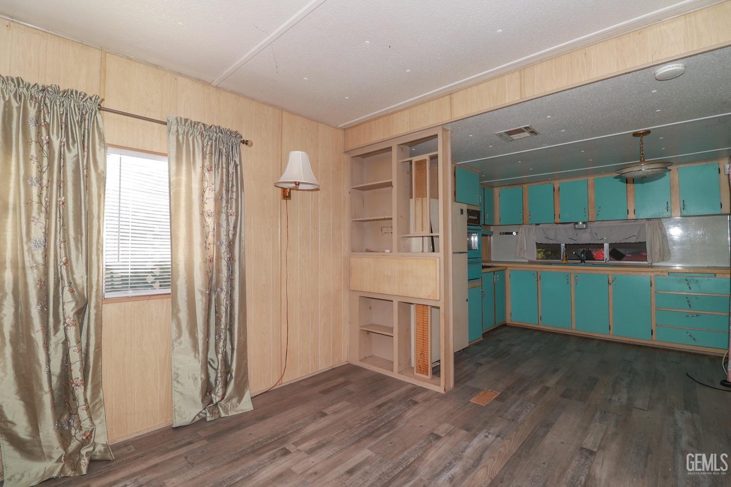 Undisclosed Address Wofford Heights, CA 93285 - Photo 11 of 26 a kitchen with a refrigerator and a wooden cabinets