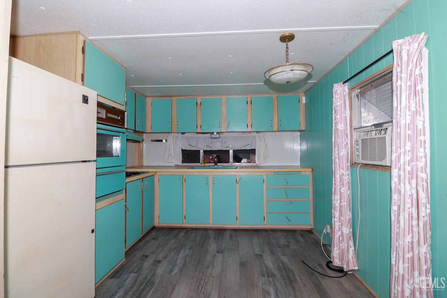 Undisclosed Address Wofford Heights, CA 93285 - Photo 12 of 26 a kitchen with a refrigerator and a sink