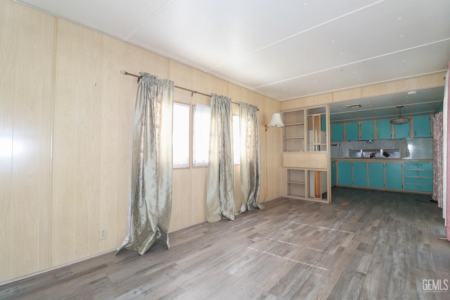 Undisclosed Address Wofford Heights, CA 93285 - Photo 25 of 26 an empty room with wooden floor and windows