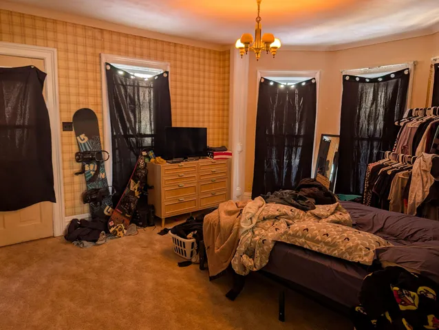 a bedroom with furniture and a flat tv screen