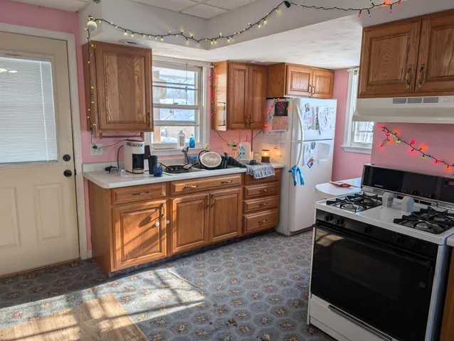 a kitchen with stainless steel appliances a stove a sink and a refrigerator