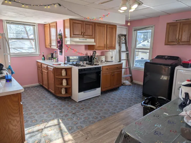 a kitchen with stainless steel appliances granite countertop a stove a sink dishwasher and a refrigerator