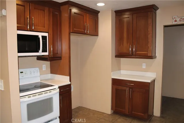a kitchen with stainless steel appliances granite countertop a stove microwave and refrigerator