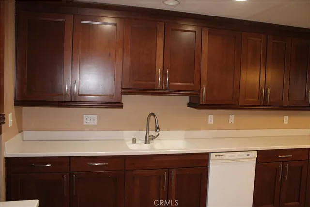 a kitchen with a sink cabinets and stainless steel appliances