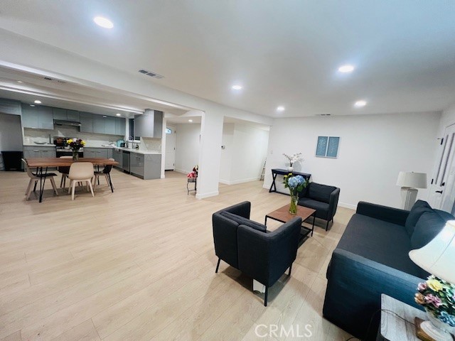 1135 Lockhaven Drive Brea, CA 92821 - Photo 11 of 35 a living room with furniture and a dining table with kitchen view