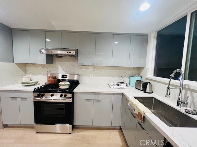 1135 Lockhaven Drive Brea, CA 92821 - Photo 19 of 35 a kitchen with stainless steel appliances granite countertop a sink stove and refrigerator