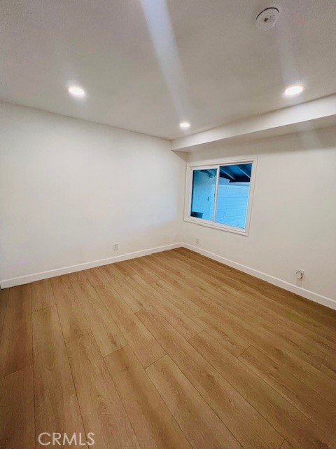 1135 Lockhaven Drive Brea, CA 92821 - Photo 30 of 35 an empty room with wooden floor and windows