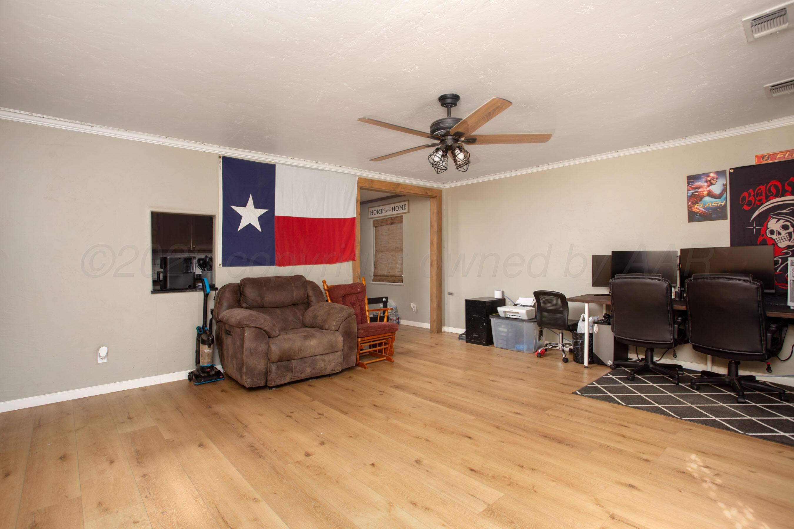 4409 South Lipscomb Street Amarillo, TX 79110 - Photo 12 of 23 a living room with furniture and a flat screen tv